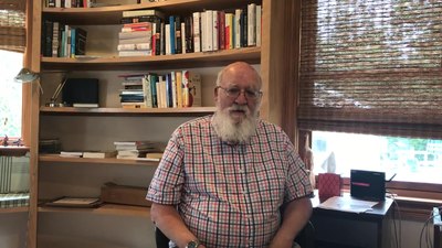 What specific branch of biology is Dennett particularly interested in?