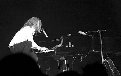 What is Tim Minchin primarily known for?