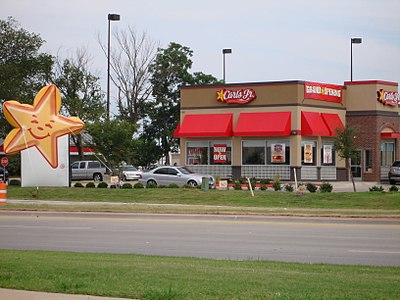 Which fast-food chain did Carl's Jr. merge with in 1997?