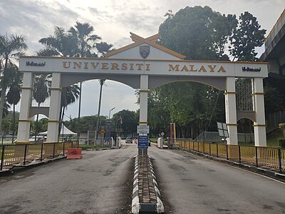 Which two institutions merged to form the University of Malaya?