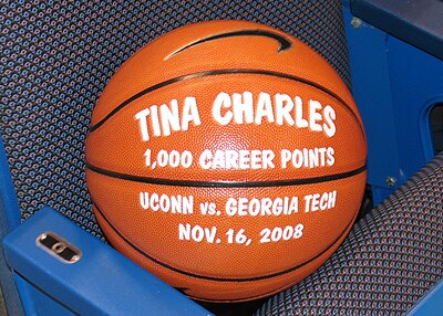 Who was Tina Charles' notable college teammate?