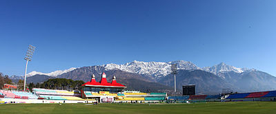 Which mountain range surrounds Dharamshala?