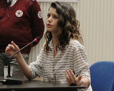 In addition to her acting career, what is Beren Saat noted for?