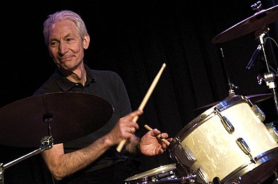 What was Charlie Watts' profession before becoming a drummer?