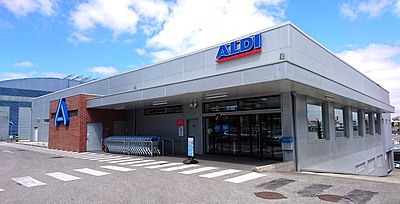 What is the formal business name of Aldi Süd?