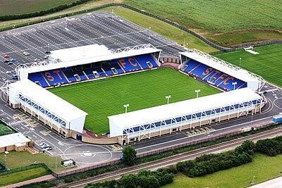 What is the name of Shrewsbury Town F.C.'s home ground?