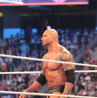 Which famous wrestler did Dave Bautista team up with to win the World Tag Team Championship twice?
