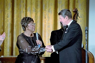 What was the name of Ella Fitzgerald's first manager?