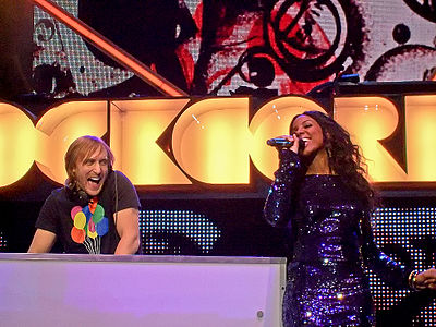 Which David Guetta song featuring Kelly Rowland topped the charts in several countries?