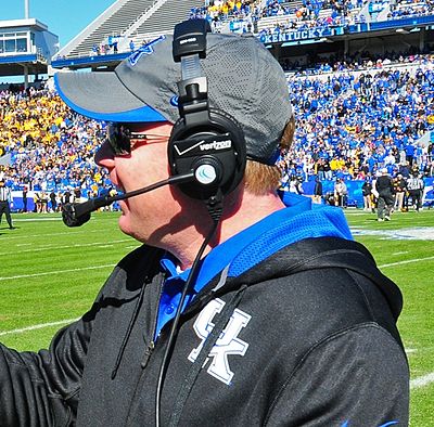 What color is predominantly featured in Kentucky's football uniforms?