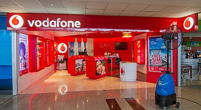 On which stock exchange does Vodafone have a primary listing?