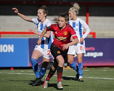 Which professional footballer plays as an attacking midfielder for Women's Super League club Manchester United?