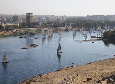 Which island in Aswan is home to the Temple of Isis?