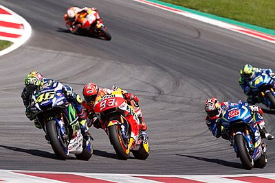 Which Italian rider has won 15 world titles in Grand Prix motorcycle racing?