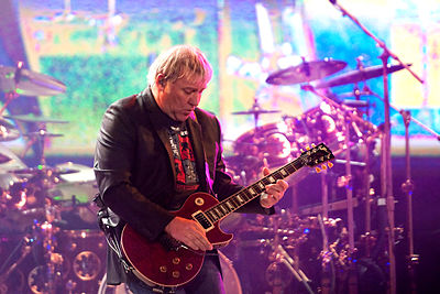 Which famous rock band is Alex Lifeson best known for playing in?