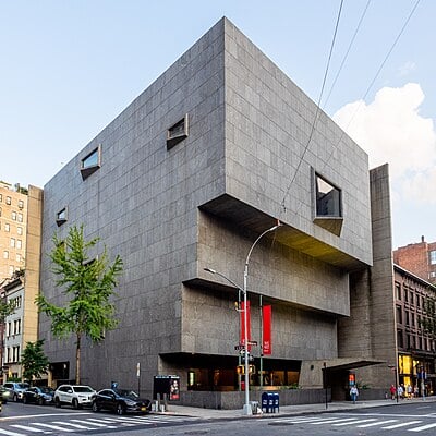 What is the name of Breuer's architectural style that emphasizes raw concrete?