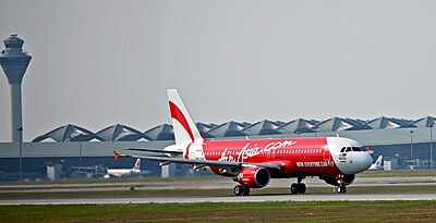 Which airport serves as the base for AirAsia's affiliate, Thai AirAsia?
