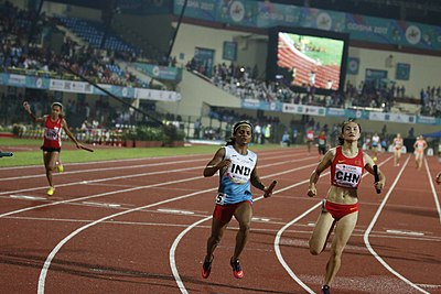 In which year did Dutee Chand win a gold medal in the 100m race at a global competition?