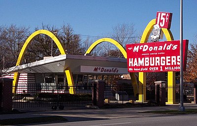 What year did Ray Kroc open the first franchised McDonald's restaurant?