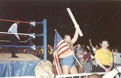 Which item is "Hacksaw" Jim Duggan famous for carrying into his matches?