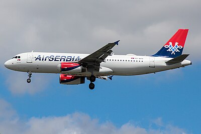 What is the name of the airport where Air Serbia's main hub is located?