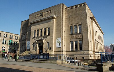 What architectural style is prominent in Huddersfield's town centre?