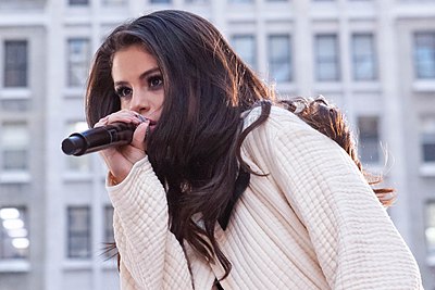What was Selena Gomez's first acting role?