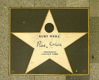 Is Kurt Weill known for his works on which themes?