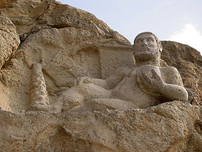 Which ancient monument is located near Kermanshah?