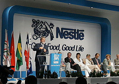 In what ticker symbol does Nestlé trade?