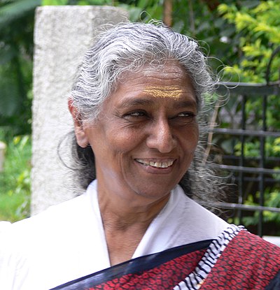 How many songs did S. Janaki sing in the very first year of her career?