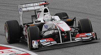 With which team did Kamui score his first F1 points?