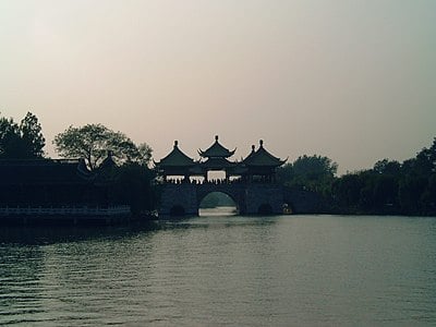 Which city in the agglomeration is NOT a part of the Yangzhou urban area?