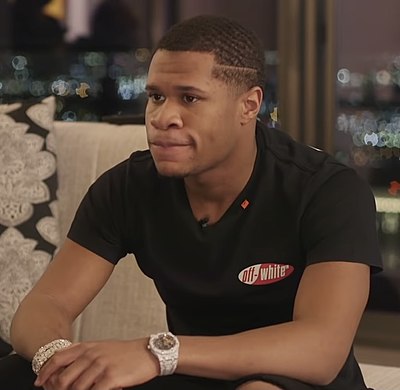 How many professional fights did Devin Haney have before winning his first world title?