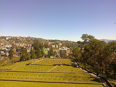 What is the geographical feature that Kohima lies on?