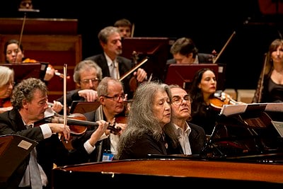 At what age did Argerich give her debut concert?