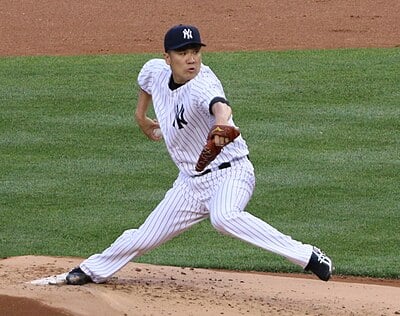 How old was Tanaka when he was drafted by the Eagles in NPB?