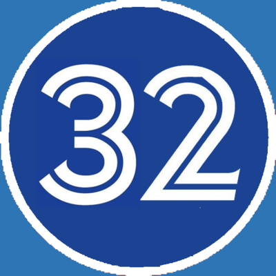 Under which team's organization number 32 was retired in honor of Roy Halladay?