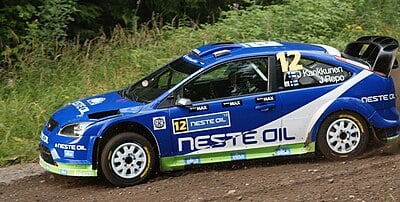 Which car company was Kankkunen with when he won his fourth title?