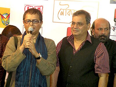 Before his career in film, where did Ghosh begin as a creative artist?
