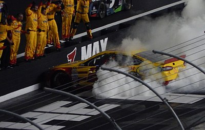 Which race marked Joey Logano's first win in the Cup Series?