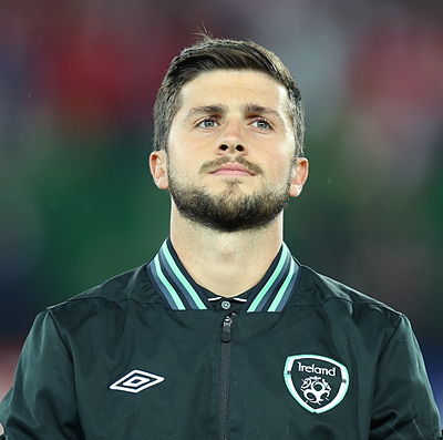 Which sport did Shane Long play early in his life alongside football?