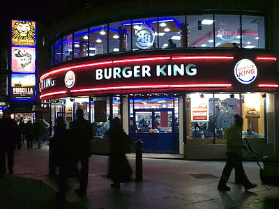 Which company merged with Burger King to form the parent company Restaurant Brands International?